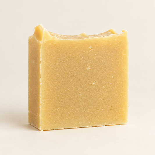 Handmade soap bar on a light neutral background, with no hands